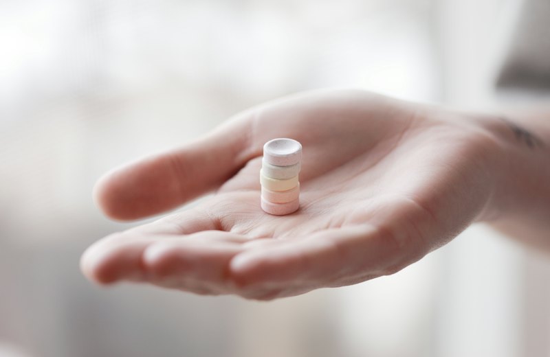 Medication tablets held in a hand