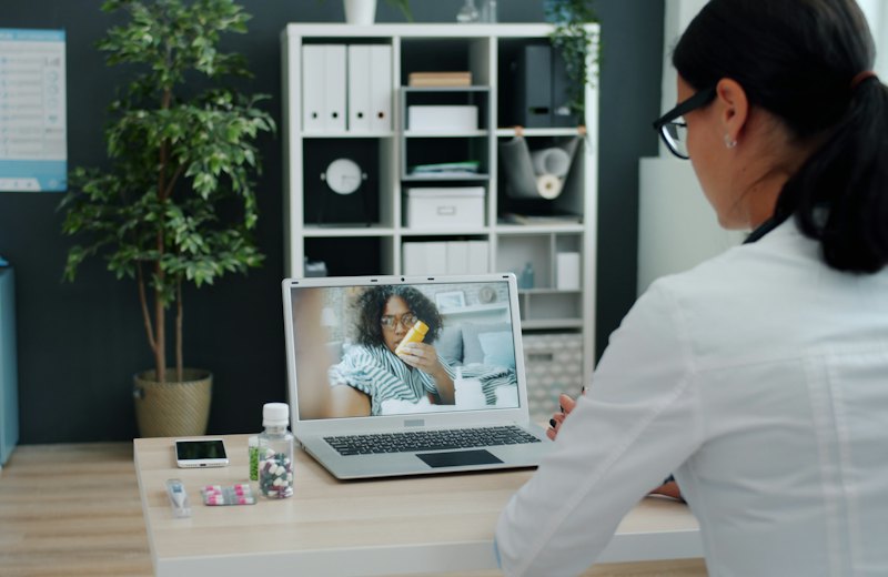 Doctor consulting a patient over video